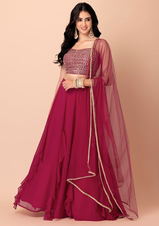 Magenta ruffle lehenga with mirror work blouse and net dupatta